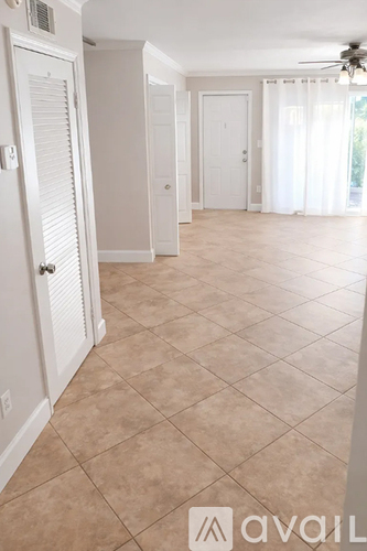 A room with tile flooring and white walls.