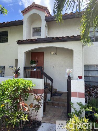 A house with a red door and a balcony.
