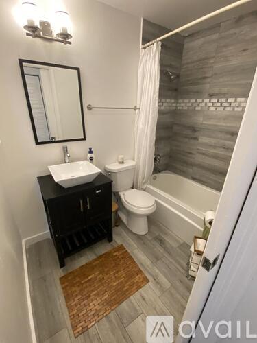 A bathroom with a sink, toilet, and bathtub.