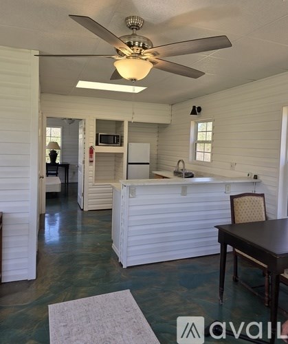 A kitchen with a table and chairs.