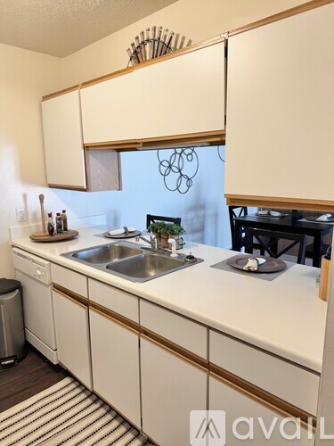 A kitchen with white cabinets and a sink.