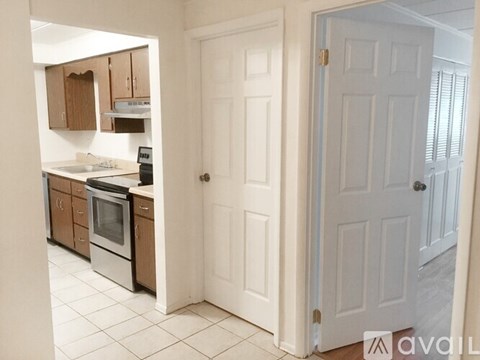 A kitchen with white cabinets and appliances is shown.