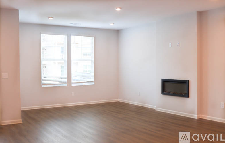 A spacious living room with a fireplace and a television.