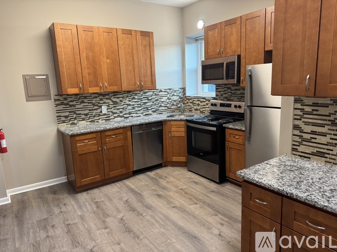 A kitchen with wooden cabinets and granite countertops.