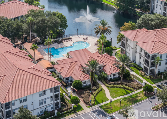 A bird's eye view of a resort with a pool and a fountain.