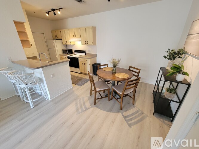 A kitchen with a dining table and chairs.