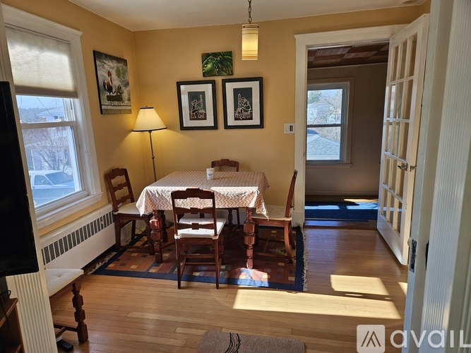 A room with a table and chairs in it.
