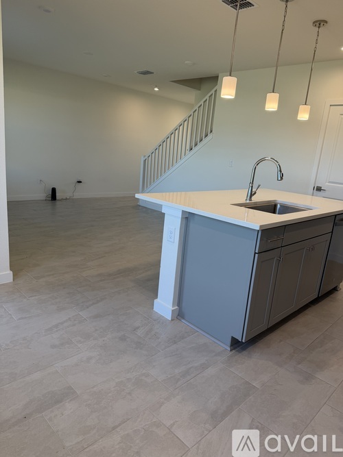 A kitchen with a sink and a stove top oven.