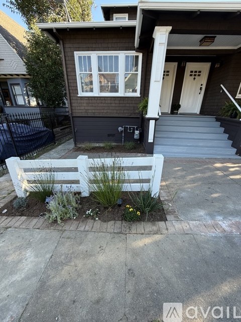 A house with a white bench in front of it.