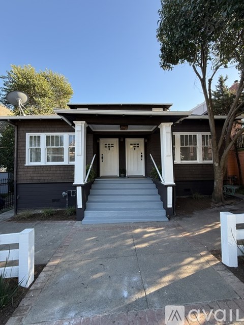 A house with a front porch and white railings.