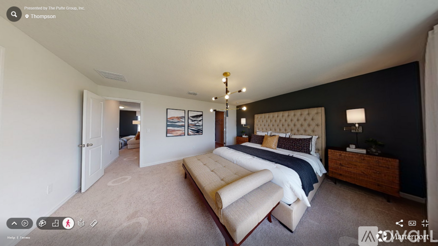 A bedroom with a large bed and a wooden dresser.