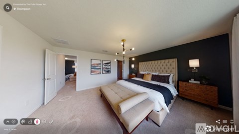A bedroom with a large bed and a wooden dresser.