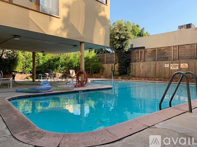 A pool with a blue water surface and a red ring float in the middle.