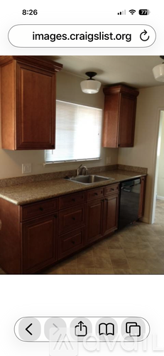 A kitchen with wooden cabinets and a granite countertop.
