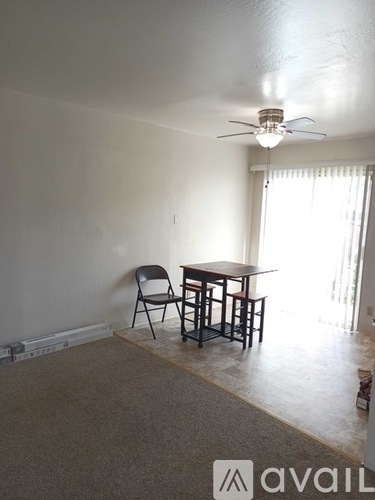A room with a table and chairs in it.