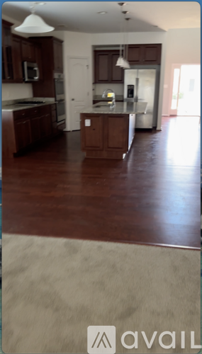 A kitchen with dark wood cabinets and a white ceiling.