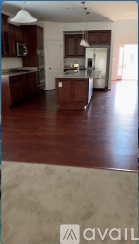 A kitchen with dark wood cabinets and a white ceiling.