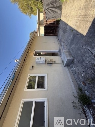 A building with a window and a door is visible.