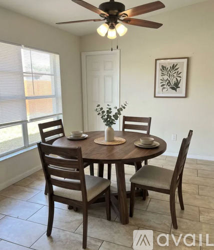 A dining room with a table set for four.