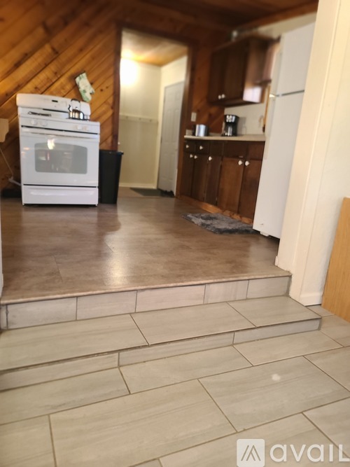 A kitchen with a white oven and a refrigerator.