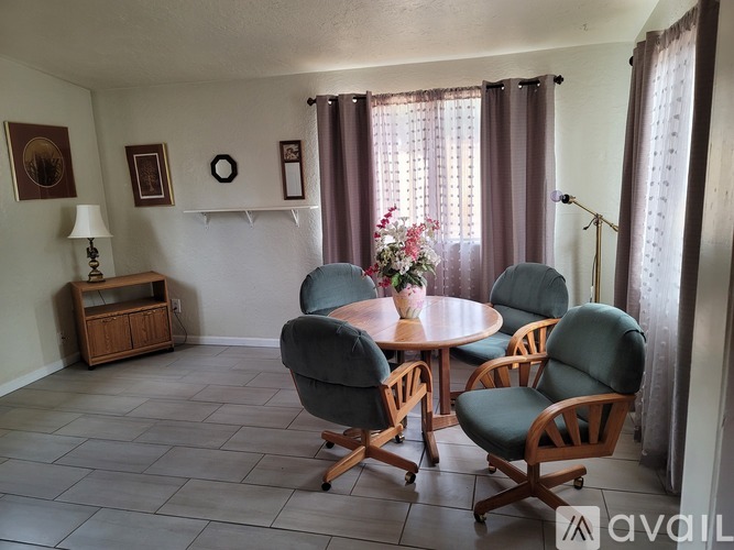 A living room with a table and chairs.