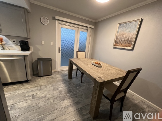 A kitchen with a table and chairs in the middle of the room.