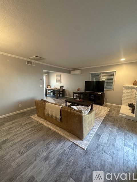 A living room with a couch and a television.