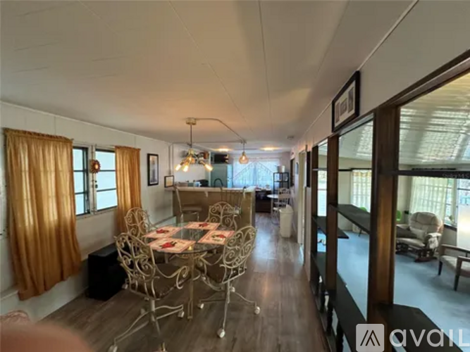 A dining area with a round table and chairs.