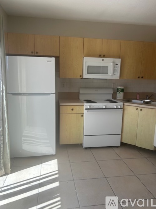 A room with a window and a door is available for rent.