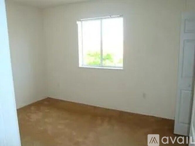 A room with a window and a door.