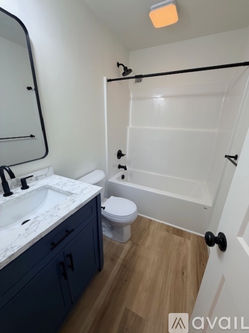 A bathroom with a white sink and a white toilet.