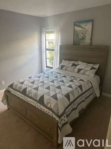 A bedroom with a bed and a window.