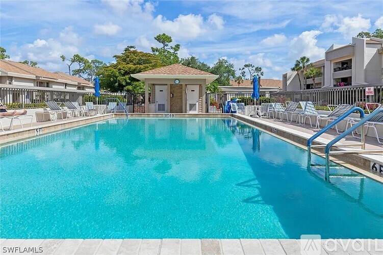 A large swimming pool with a small building in the middle.