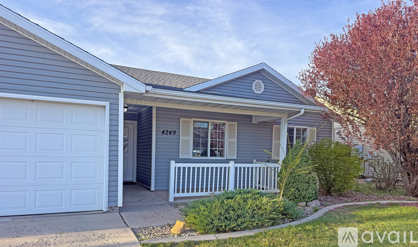 A house with a garage and a porch is for sale.