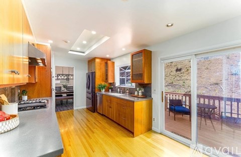 A modern kitchen with wooden cabinets and a large island.