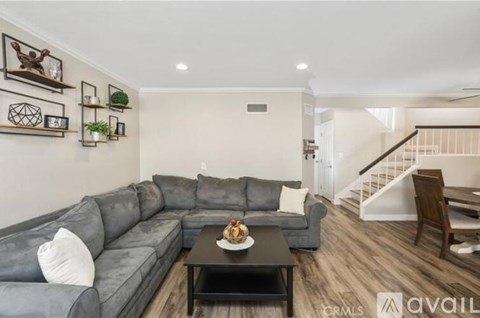 A living room with a grey sofa and a coffee table in front of it.