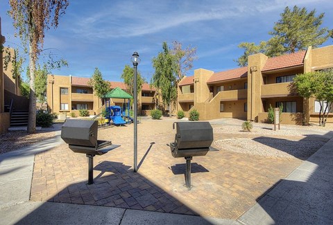 Two benches are placed in front of a building.