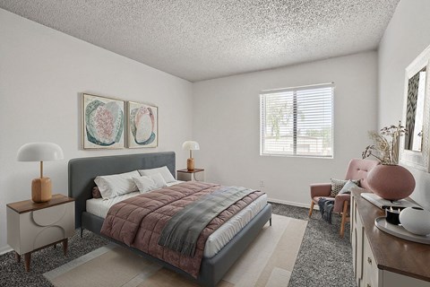 A bedroom with a bed, chair, and two lamps.