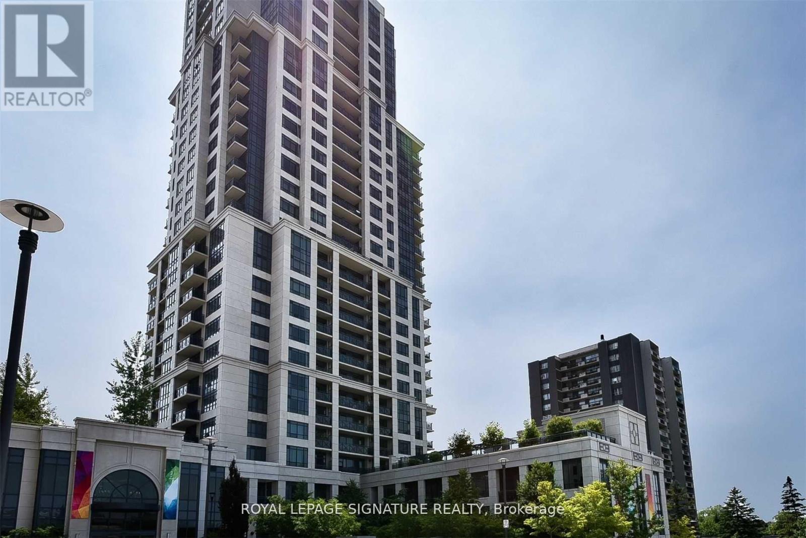 A tall building with a sign that says Royal LePage Signature Realty, Brokerage.