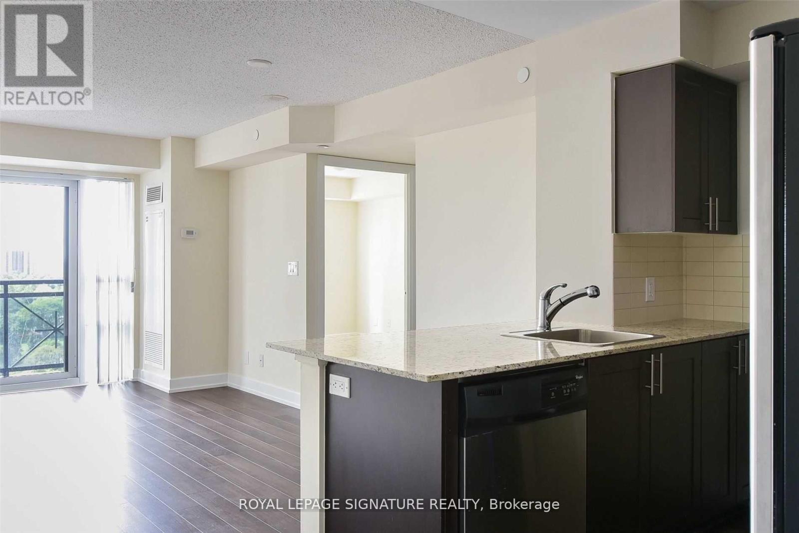 A kitchen with a sink and a dishwasher.