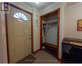 A bedroom with a wooden dresser and a mirror.