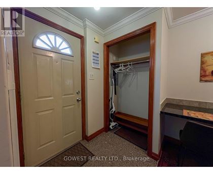 A bedroom with a wooden dresser and a mirror.