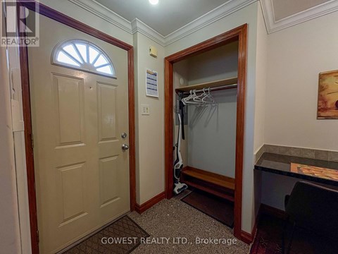A bedroom with a wooden dresser and a mirror.