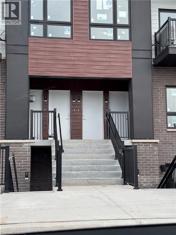 A building with a white door and a black railing.