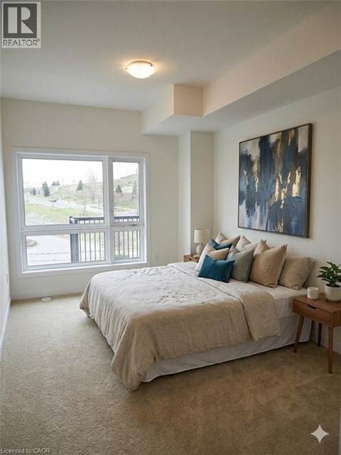 A bedroom with a large bed and a painting on the wall.