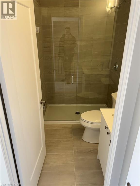 A bathroom with a toilet and a walk-in shower.