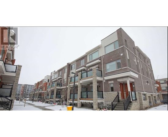 A building with a red door is in the middle of a snowy street.