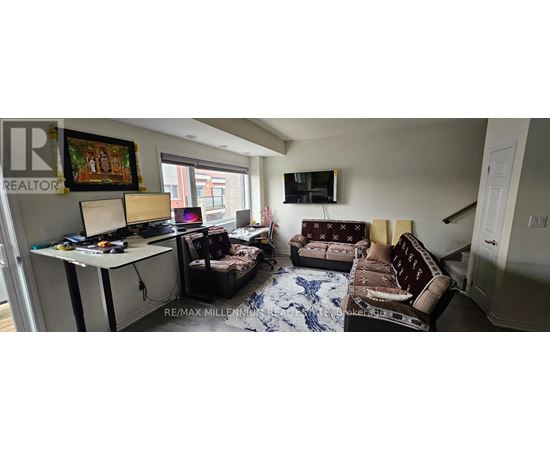 A living room with a couch, a chair, and a television.