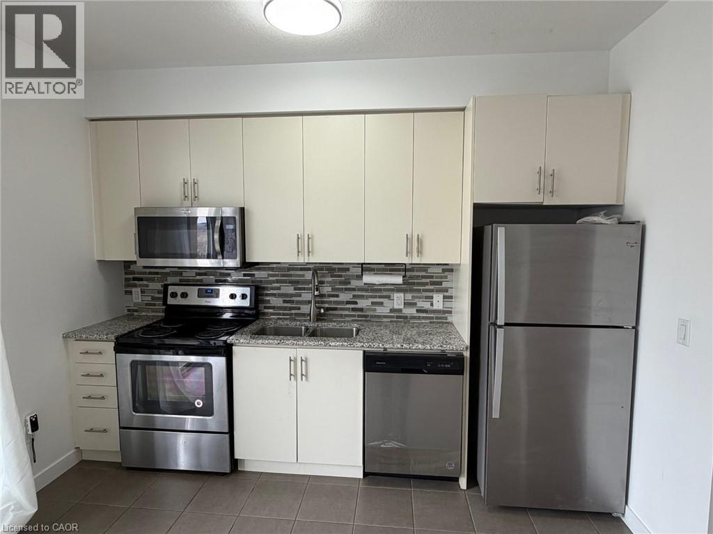 A kitchen with white cabinets and stainless steel appliances.