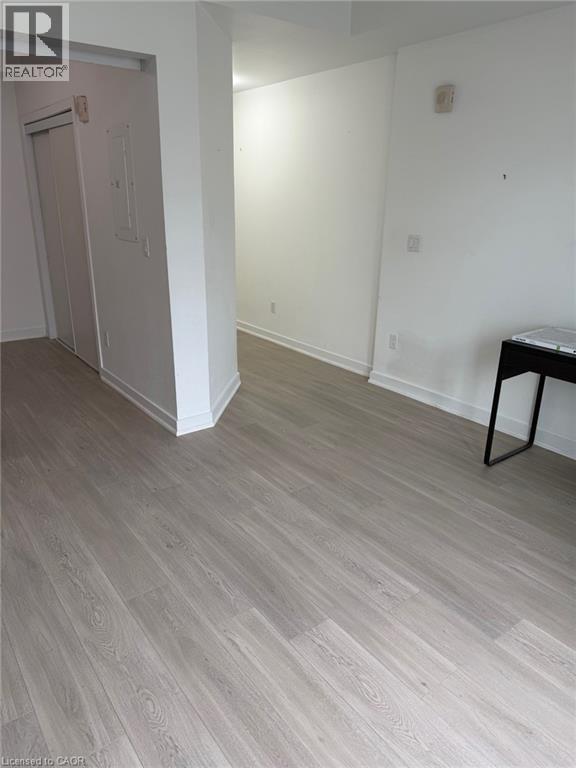 A room with a wooden floor and white walls.